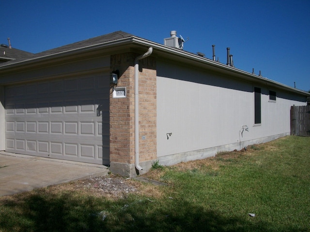 view of property exterior featuring a garage, concrete driveway, and a yard