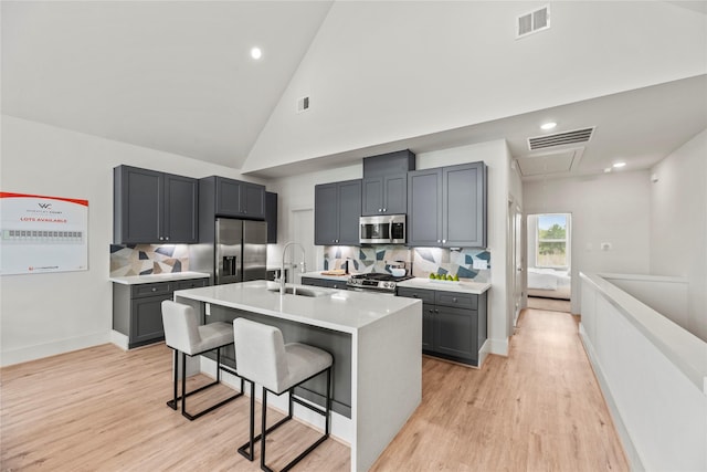 1046 Homer St, Houston, TX 77091 - kitchen with visible vents, a sink, a kitchen bar, and appliances with stainless steel finishes