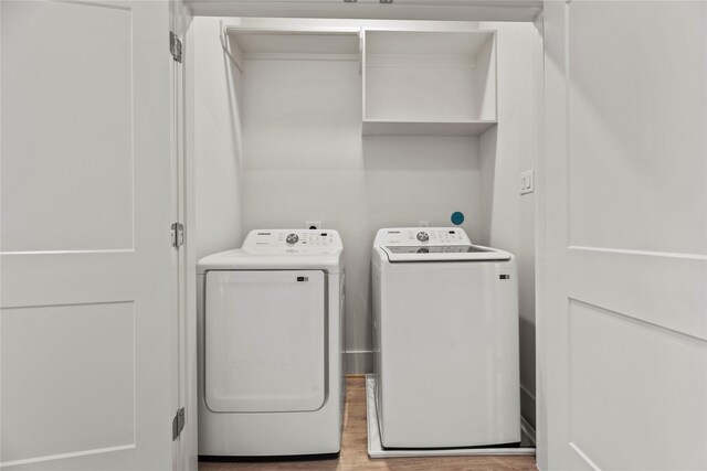 1046 Homer St, Houston, TX 77091 - washroom with washing machine and dryer, wood finished floors, and laundry area