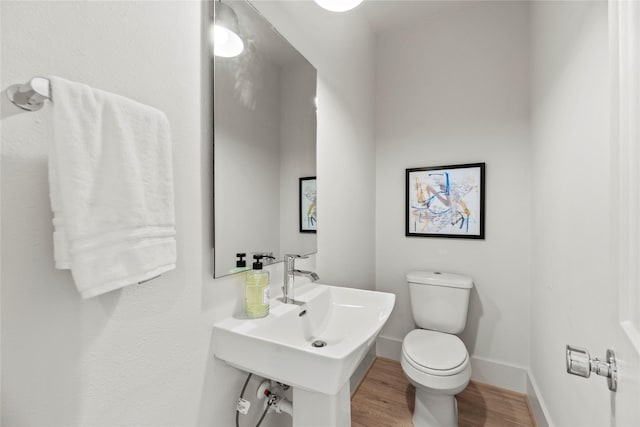 1046 Homer St, Houston, TX 77091 - half bathroom with baseboards, wood finished floors, and toilet