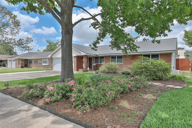 2427 Willowby Dr, Houston, TX 77008 - ranch-style house featuring fence, driveway, brick siding, a front yard, and a garage