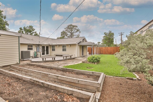 2427 Willowby Dr, Houston, TX 77008 - rear view of house featuring central air condition unit, a lawn, fence, a patio, and a garden