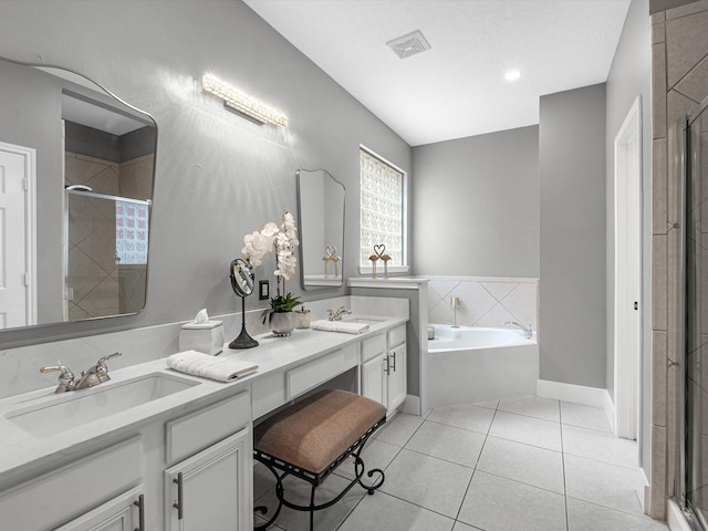 5410 Bur Oak Dr, Pasadena, TX 77505 - bathroom with a shower stall, double vanity, a bath, and tile patterned flooring