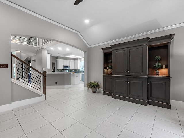 5410 Bur Oak Dr, Pasadena, TX 77505 - unfurnished living room with arched walkways, ornamental molding, vaulted ceiling, light tile patterned flooring, and stairway