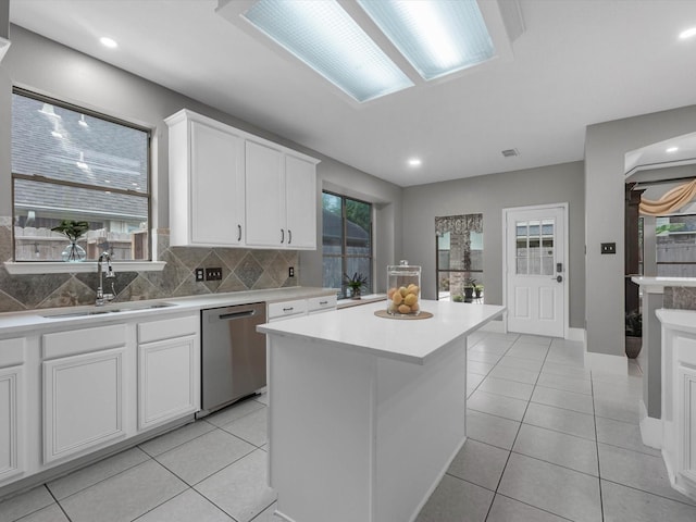5410 Bur Oak Dr, Pasadena, TX 77505 - kitchen with stainless steel dishwasher, healthy amount of natural light, white cabinets, a center island, and recessed lighting