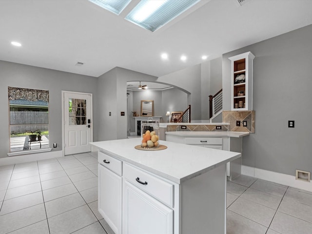5410 Bur Oak Dr, Pasadena, TX 77505 - kitchen with arched walkways, light countertops, light tile patterned floors, a kitchen island, and recessed lighting