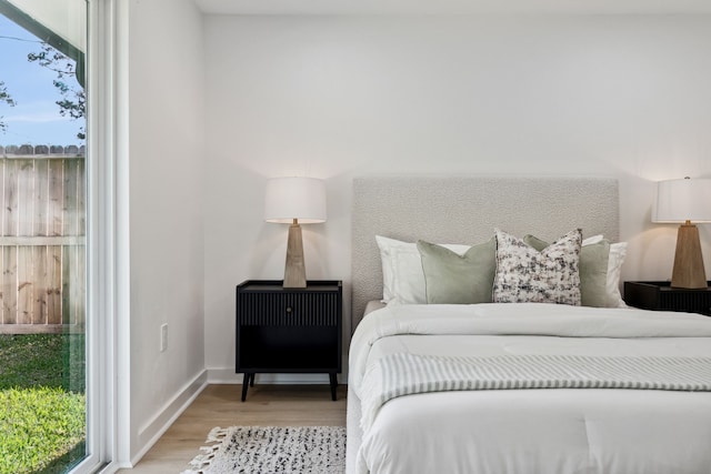 bedroom featuring baseboards and wood finished floors