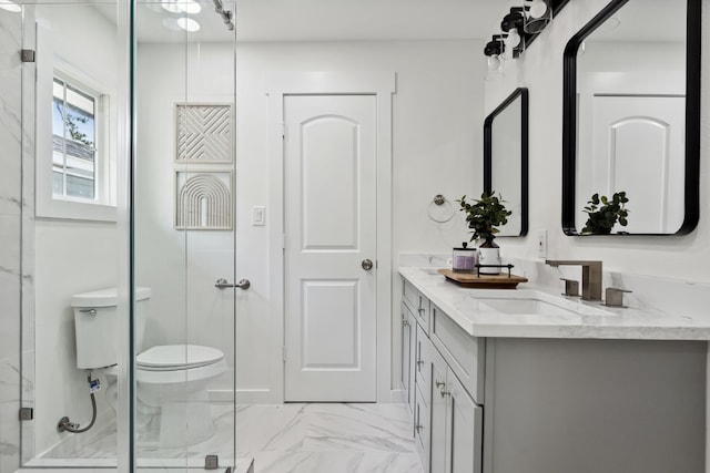 bathroom featuring a shower with shower door, marble finish floor, vanity, and toilet