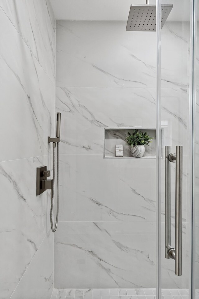 room details featuring a marble finish shower