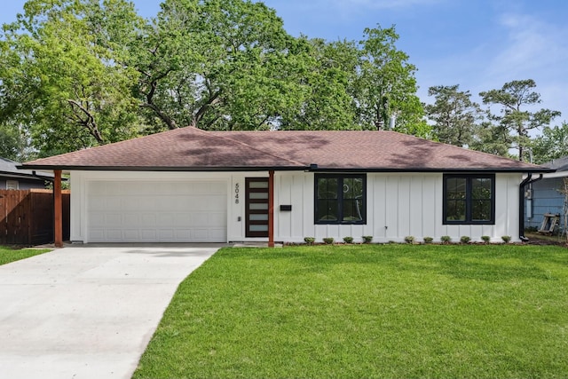 single story home featuring board and batten siding, an attached garage, fence, and roof with shingles