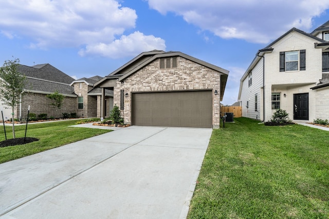 view of front of home featuring a garage, a front lawn, and brick siding