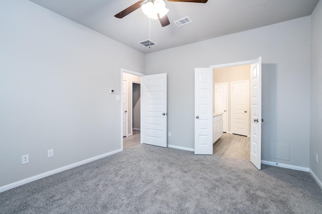 unfurnished bedroom with baseboards, ceiling fan, carpet, and visible vents