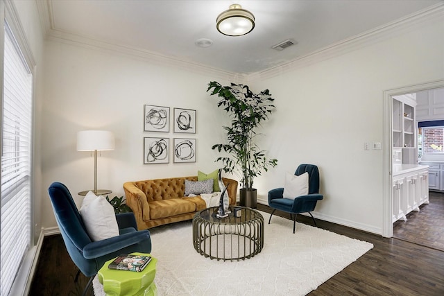 living room featuring dark wood finished floors, visible vents, crown molding, and baseboards