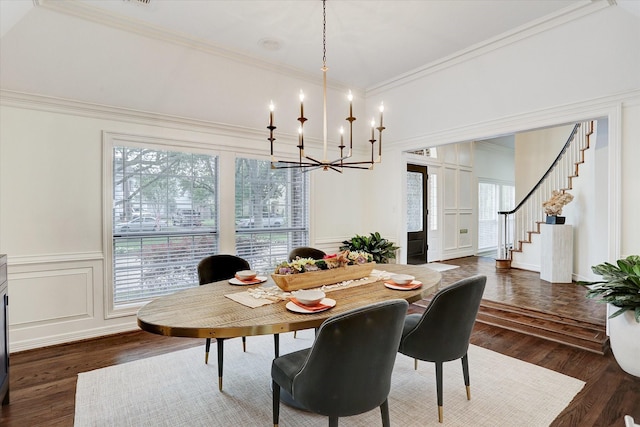 dining space featuring a decorative wall, a notable chandelier, ornamental molding, and a healthy amount of sunlight