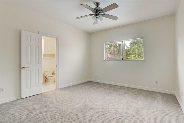 unfurnished bedroom featuring carpet flooring, baseboards, and ornamental molding