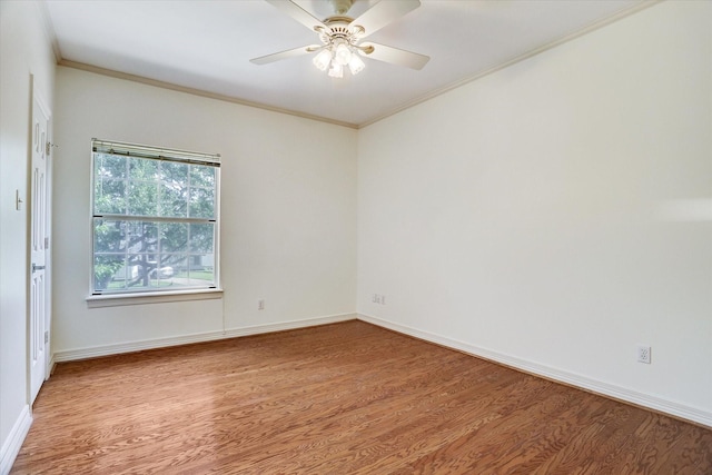 unfurnished room with baseboards, crown molding, and light wood-style floors