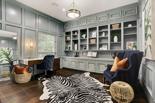 office space with a decorative wall and dark wood-style floors