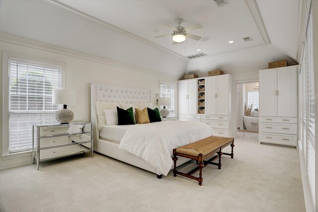 bedroom with lofted ceiling, light carpet, multiple windows, and visible vents