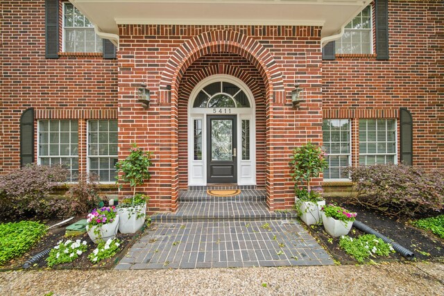 doorway to property with brick siding
