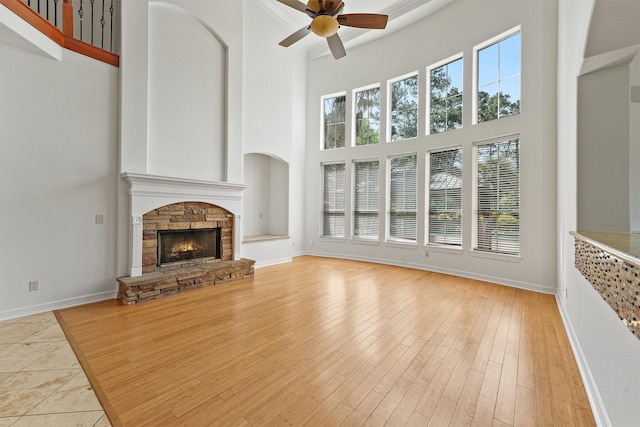 23056 Volga Dr, Porter, TX 77365 - unfurnished living room with baseboards, a stone fireplace, a towering ceiling, and ceiling fan