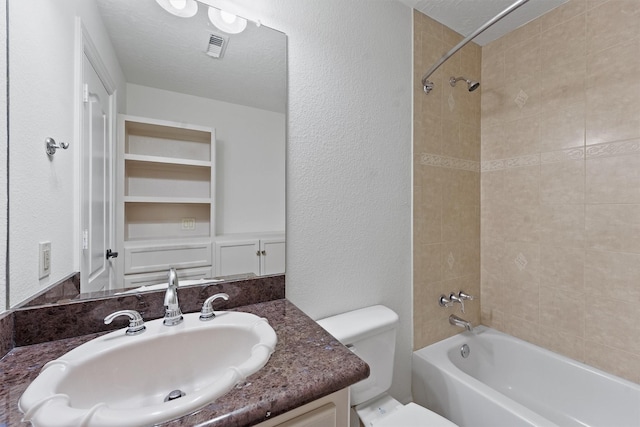23056 Volga Dr, Porter, TX 77365 - full bath featuring a textured wall, visible vents, toilet, vanity, and bathtub / shower combination
