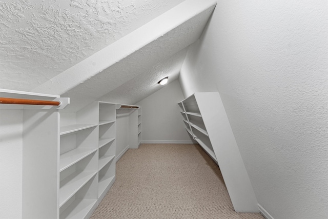 23056 Volga Dr, Porter, TX 77365 - walk in closet with vaulted ceiling and light colored carpet