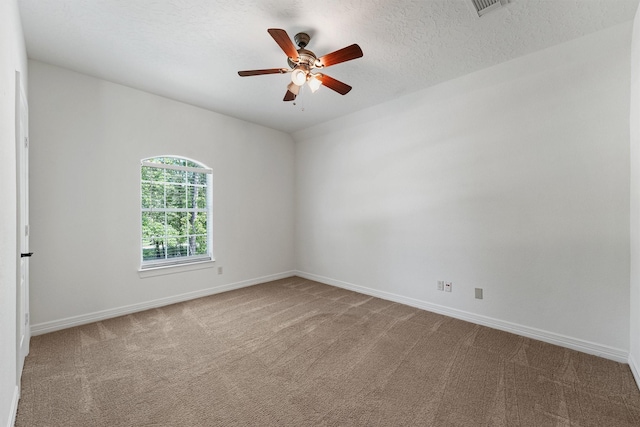 23056 Volga Dr, Porter, TX 77365 - carpeted spare room featuring baseboards, a ceiling fan, and a textured ceiling