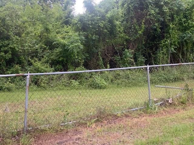 view of gate featuring fence and a yard