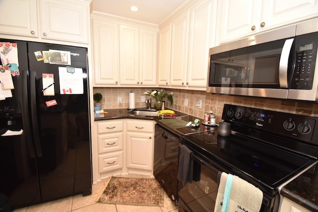 6413 Ella Lee Ln, Houston, TX 77057 - kitchen with light tile patterned floors, a sink, black appliances, and tasteful backsplash