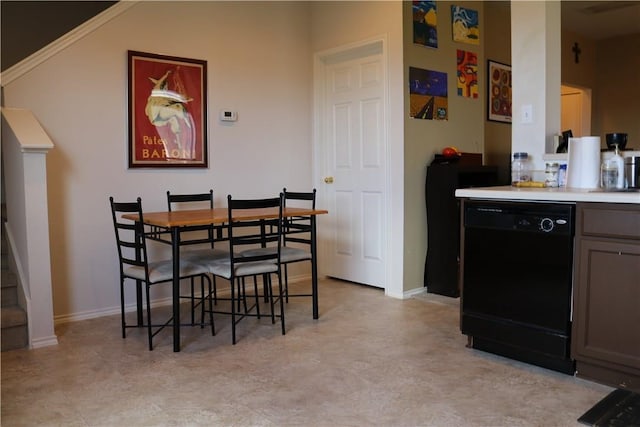 dining area featuring baseboards and a dry bar