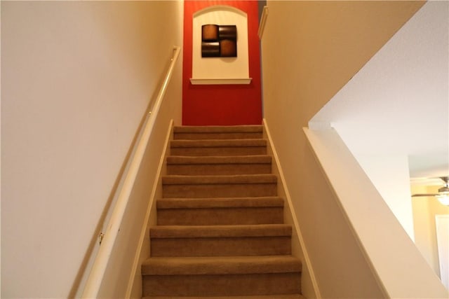 staircase with a ceiling fan