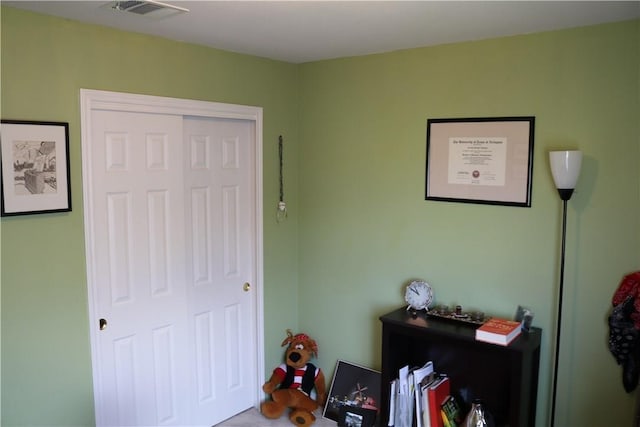 bedroom featuring a closet and visible vents
