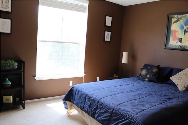 bedroom with baseboards and carpet