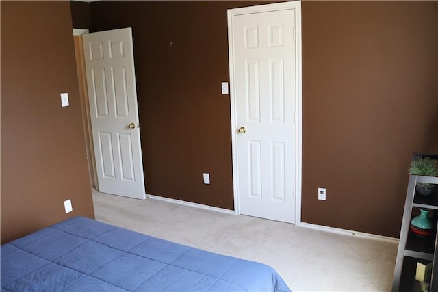 carpeted bedroom featuring baseboards