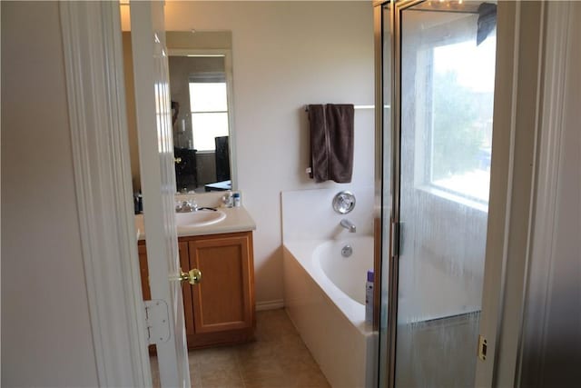 full bath featuring a bath, tile patterned floors, and vanity