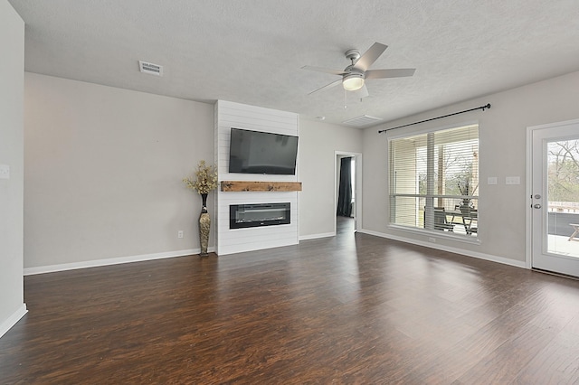 unfurnished living room featuring ceiling fan, baseboards, wood finished floors, and visible vents