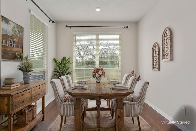 dining area featuring wood finished floors and baseboards