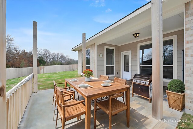 view of patio / terrace featuring outdoor dining area, grilling area, and a fenced backyard