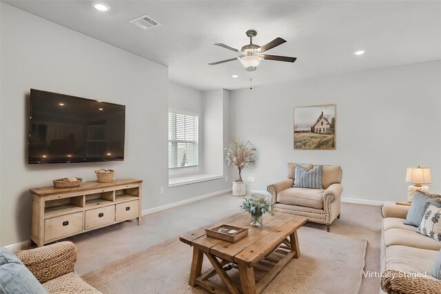 carpeted living area with recessed lighting, visible vents, baseboards, and ceiling fan