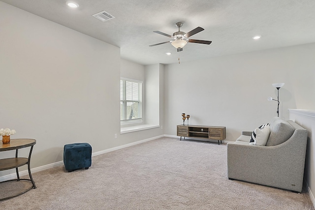 living area with a ceiling fan, visible vents, recessed lighting, and carpet flooring