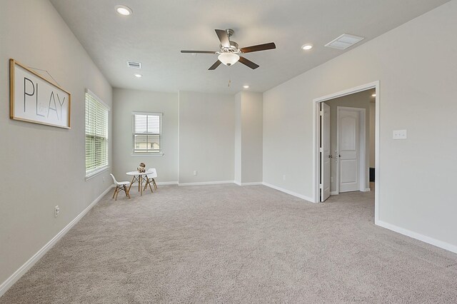 empty room featuring ceiling fan, light carpet, and recessed lighting