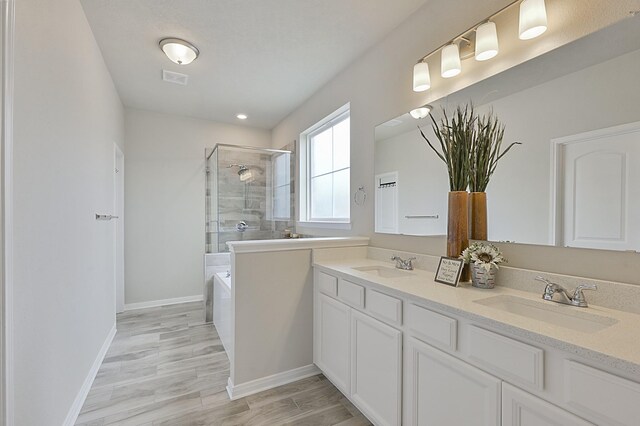 full bath with a shower stall, baseboards, and a sink