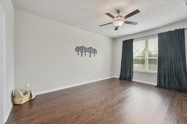 unfurnished room with dark wood finished floors, baseboards, a ceiling fan, and a textured ceiling