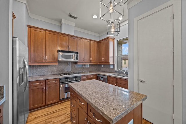 5212 Lillian St, Houston, TX 77007 - kitchen with stainless steel appliances, a sink, brown cabinetry, crown molding, and tasteful backsplash