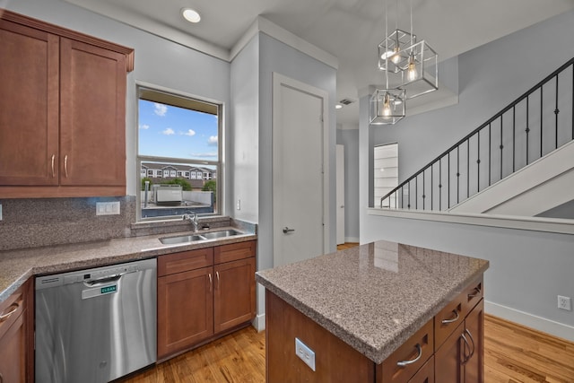 5212 Lillian St, Houston, TX 77007 - kitchen with stainless steel dishwasher, a sink, brown cabinetry, and light wood-style flooring