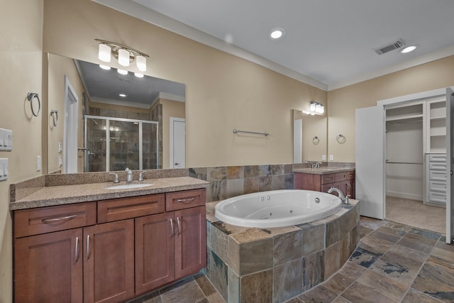 5212 Lillian St, Houston, TX 77007 - full bathroom featuring a shower stall, stone tile floors, a tub with jets, two vanities, and crown molding