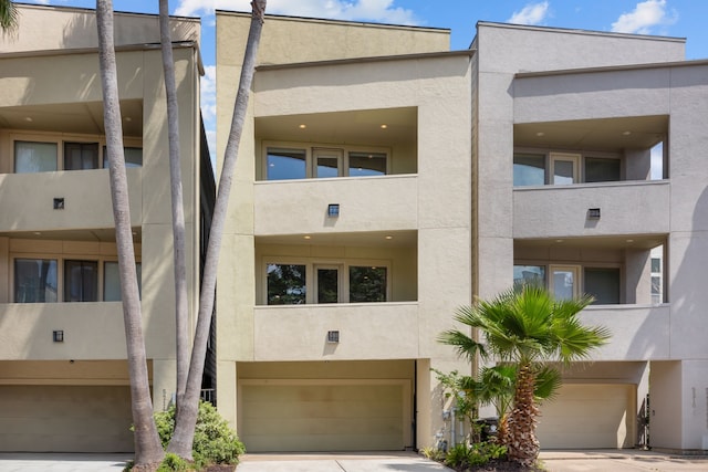5212 Lillian St, Houston, TX 77007 - view of apartment building / complex with a garage and concrete driveway