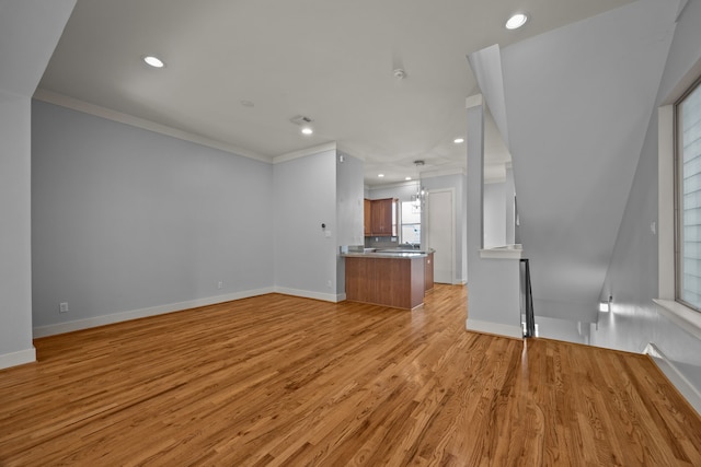 5212 Lillian St, Houston, TX 77007 - unfurnished living room with ornamental molding, light wood-type flooring, recessed lighting, and baseboards