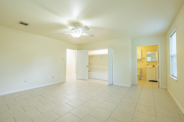 5003 Lord Rd, Crosby, TX 77532 - unfurnished bedroom with ceiling fan, visible vents, multiple windows, and light tile patterned floors