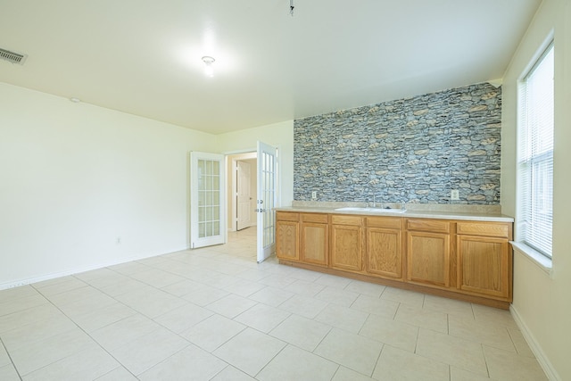 5003 Lord Rd, Crosby, TX 77532 - spare room featuring visible vents, a wealth of natural light, a sink, and french doors